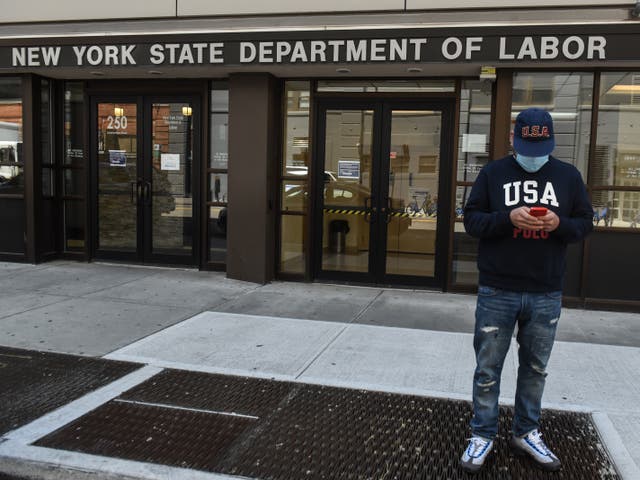 <p>Luis Mora stands in front of the closed offices of the New York State Department of Labor on May 7, 2020 in the Brooklyn borough in New York City</p>