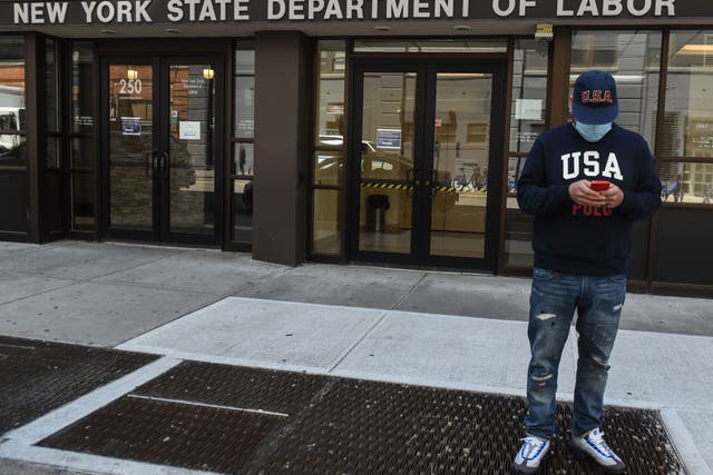 <p>Luis Mora stands in front of the closed offices of the New York State Department of Labor on May 7, 2020 in the Brooklyn borough in New York City</p>