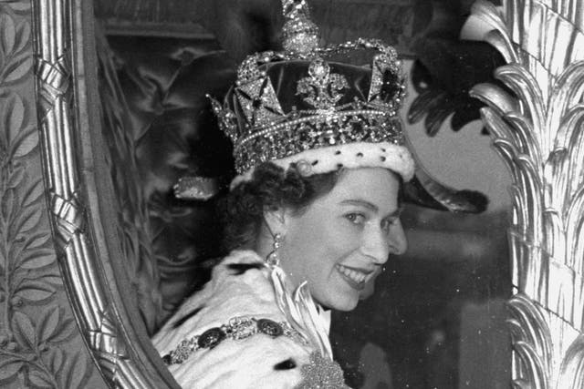 The Queen gives a wide smile for the crowd from her carriage as she leaves Westminster Abbey, London, after her Coronation (PA)
