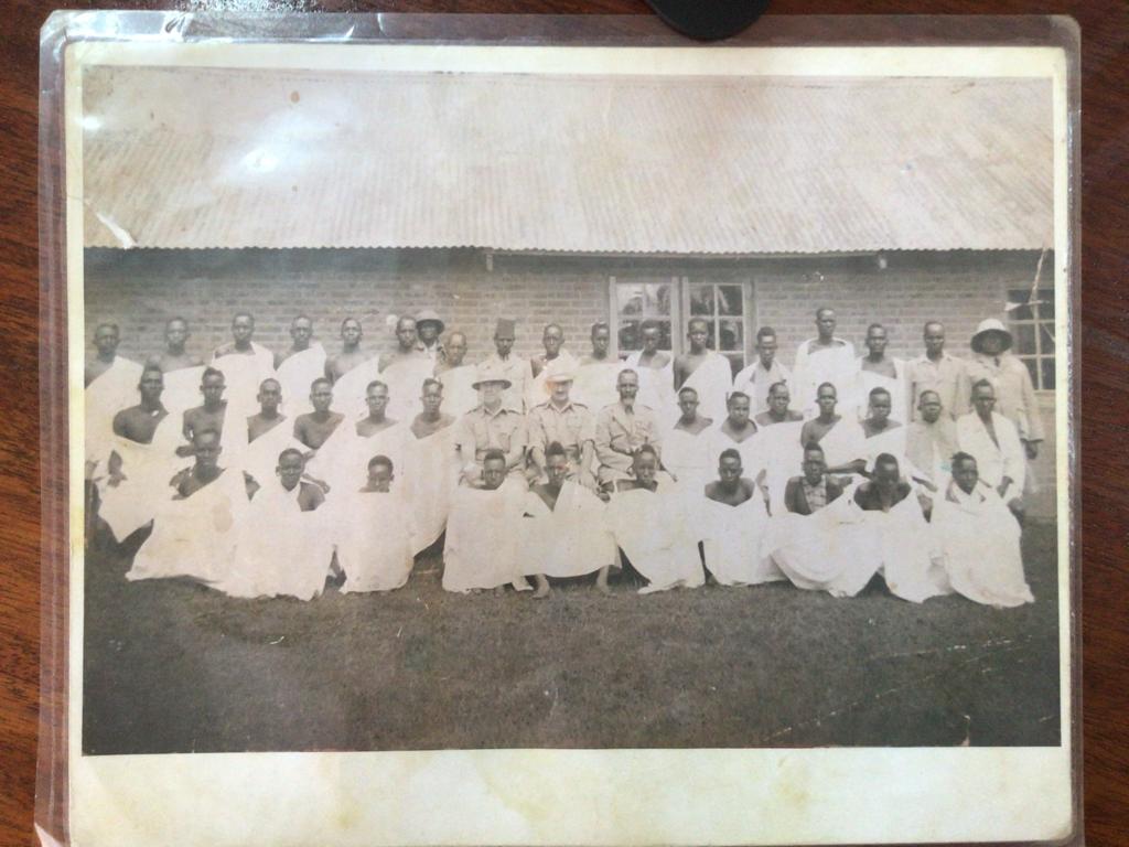 Kenyans who had been evicted from their land photographed while being held at the Kericho Detention centre, made to pose alongside British Colonial officers they were made to pose with