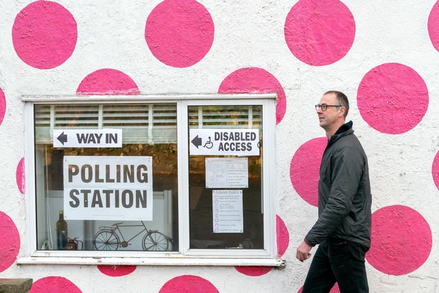 <p>A man walks past a polling station in the Bank View Cafe, Sheffield (Danny Lawson/PA)</p>