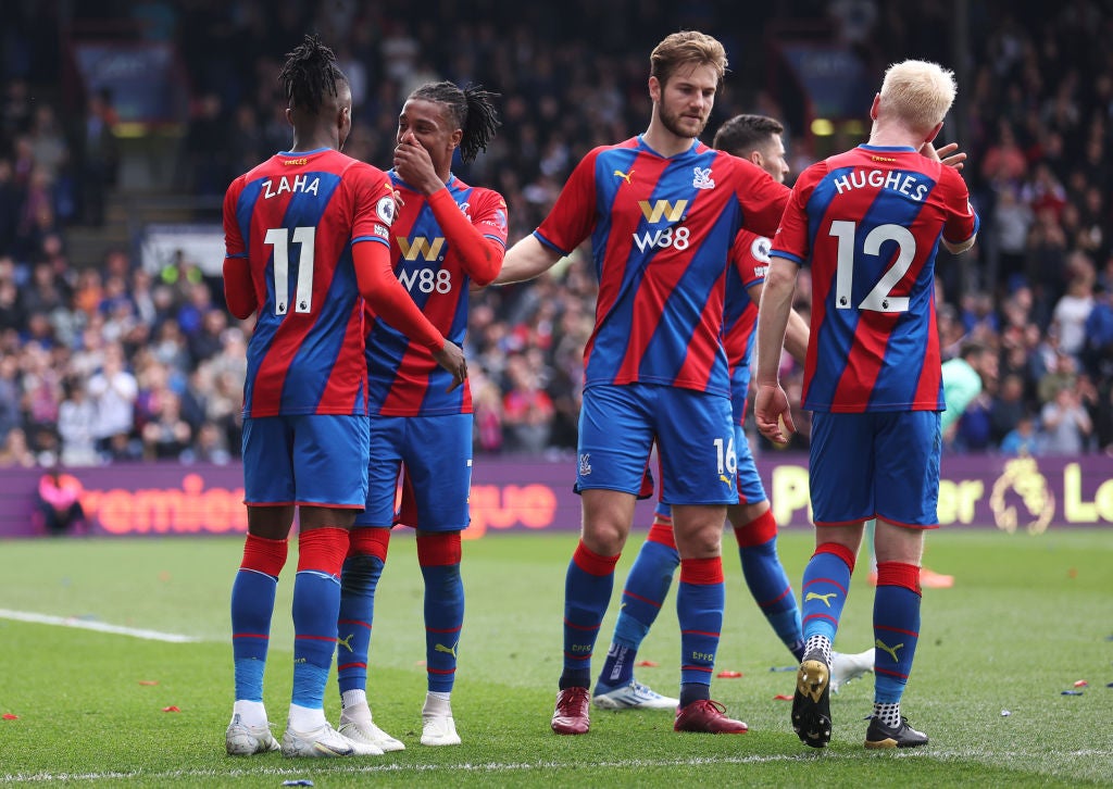 Wilfried Zaha is congratulated by his Crystal Palace teammates after scoring from the spot
