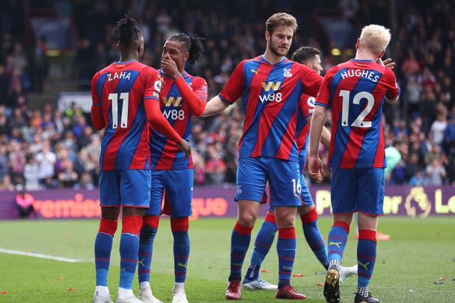 <p>Wilfried Zaha is congratulated by his Crystal Palace teammates after scoring from the spot </p>