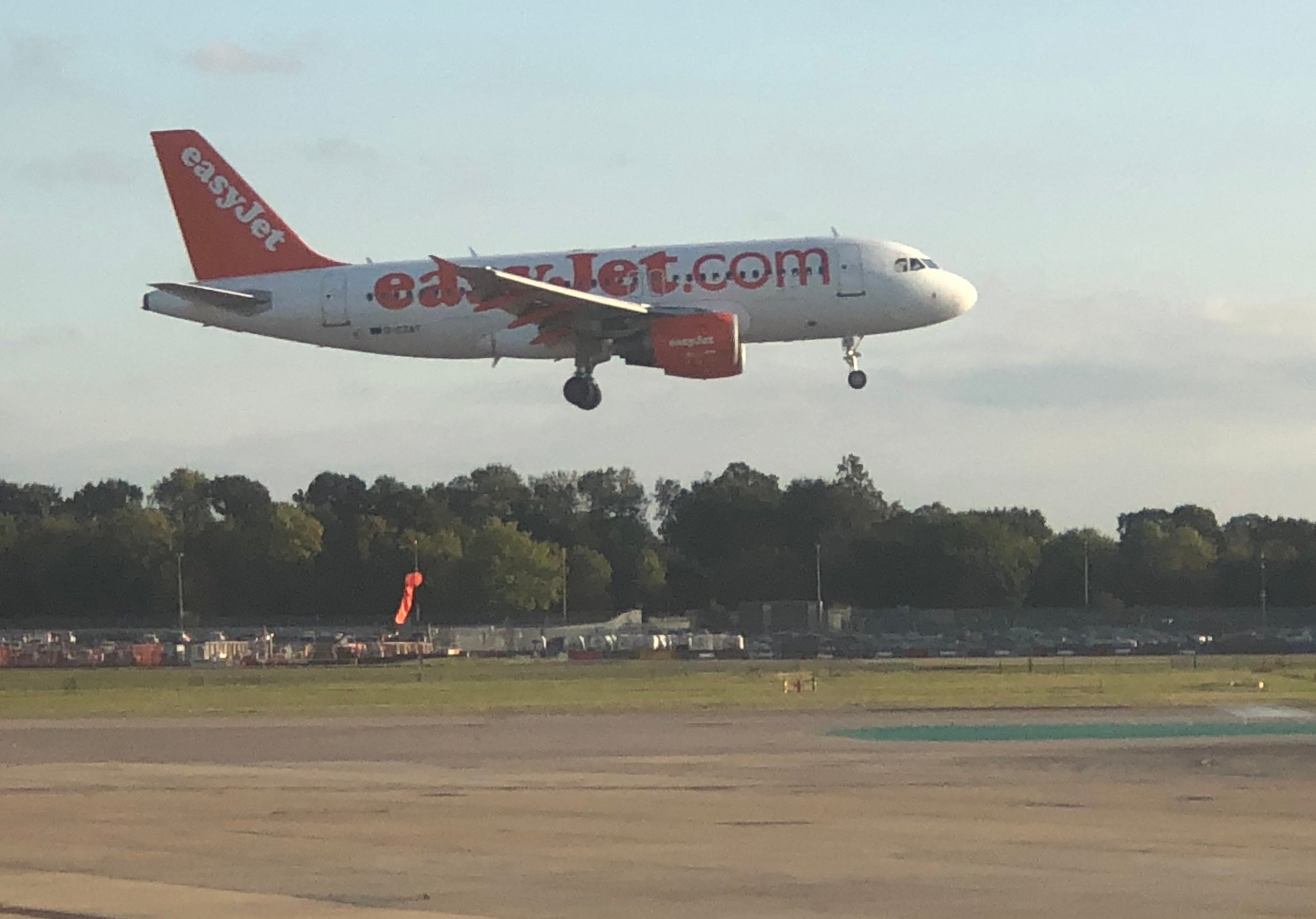 <p>An easyJet Airbus A319 landing at Gatwick</p>
