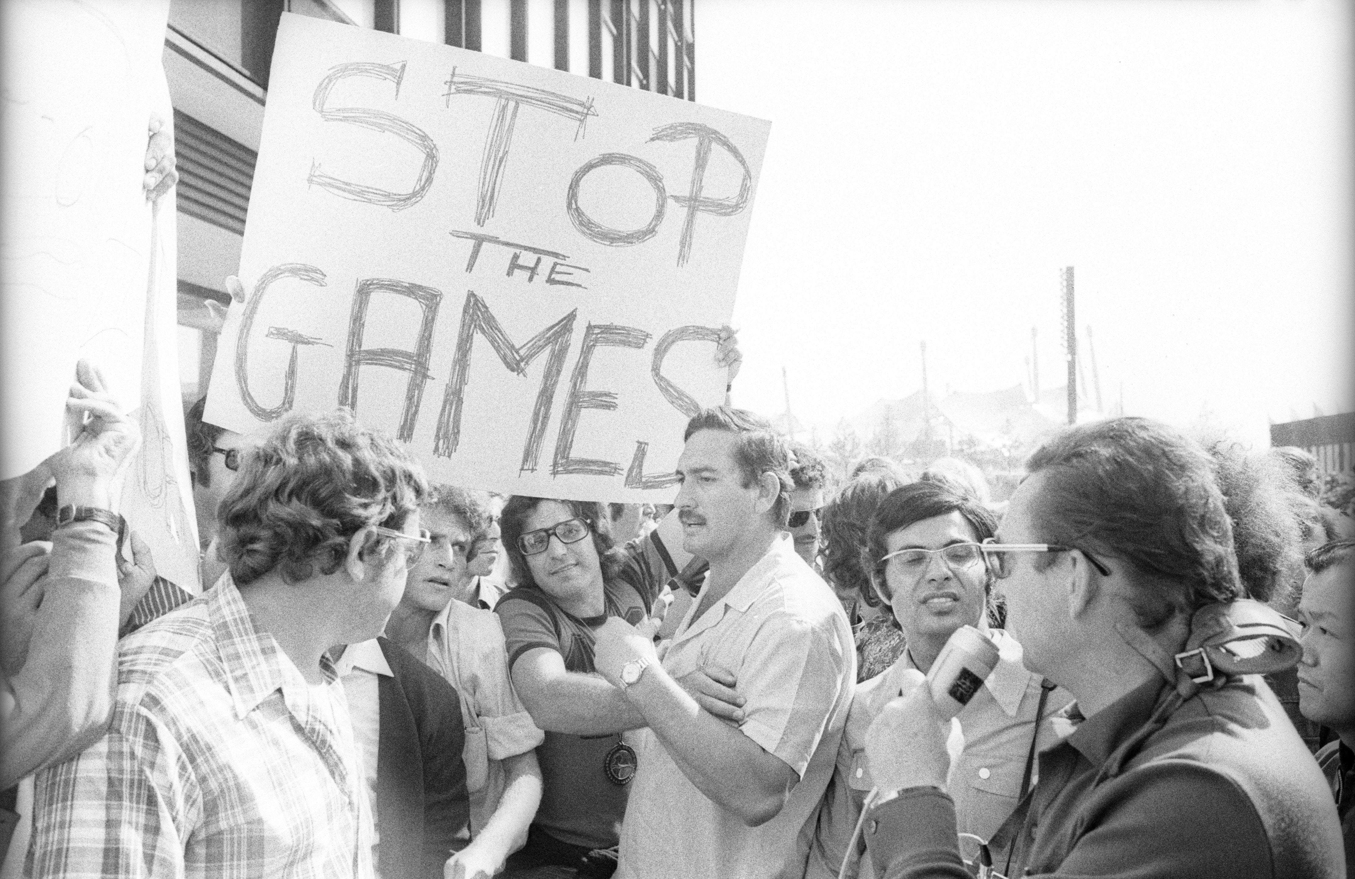 Demonstrators march in support of the Israeli Olympic team and demand an end to the Games