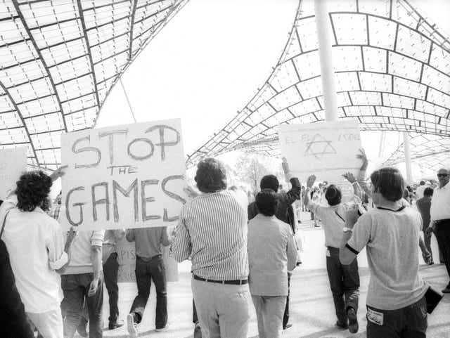 <p>Demonstrators demand an end to the Games while hostages are being held</p>