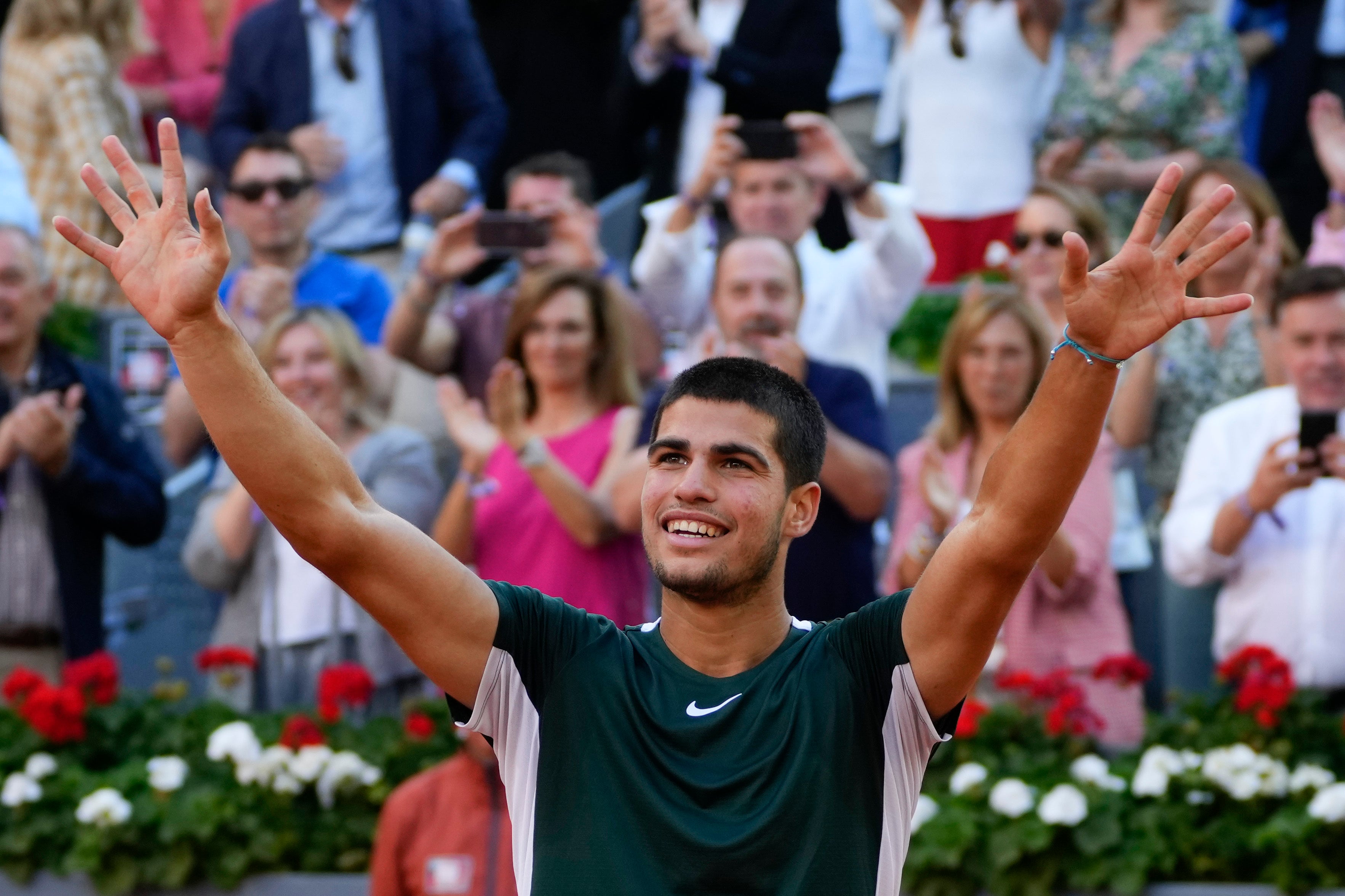 Carlos Alcaraz celebrates after defeating Alexander Zverev in the Madrid Open final (Paul White/AP)