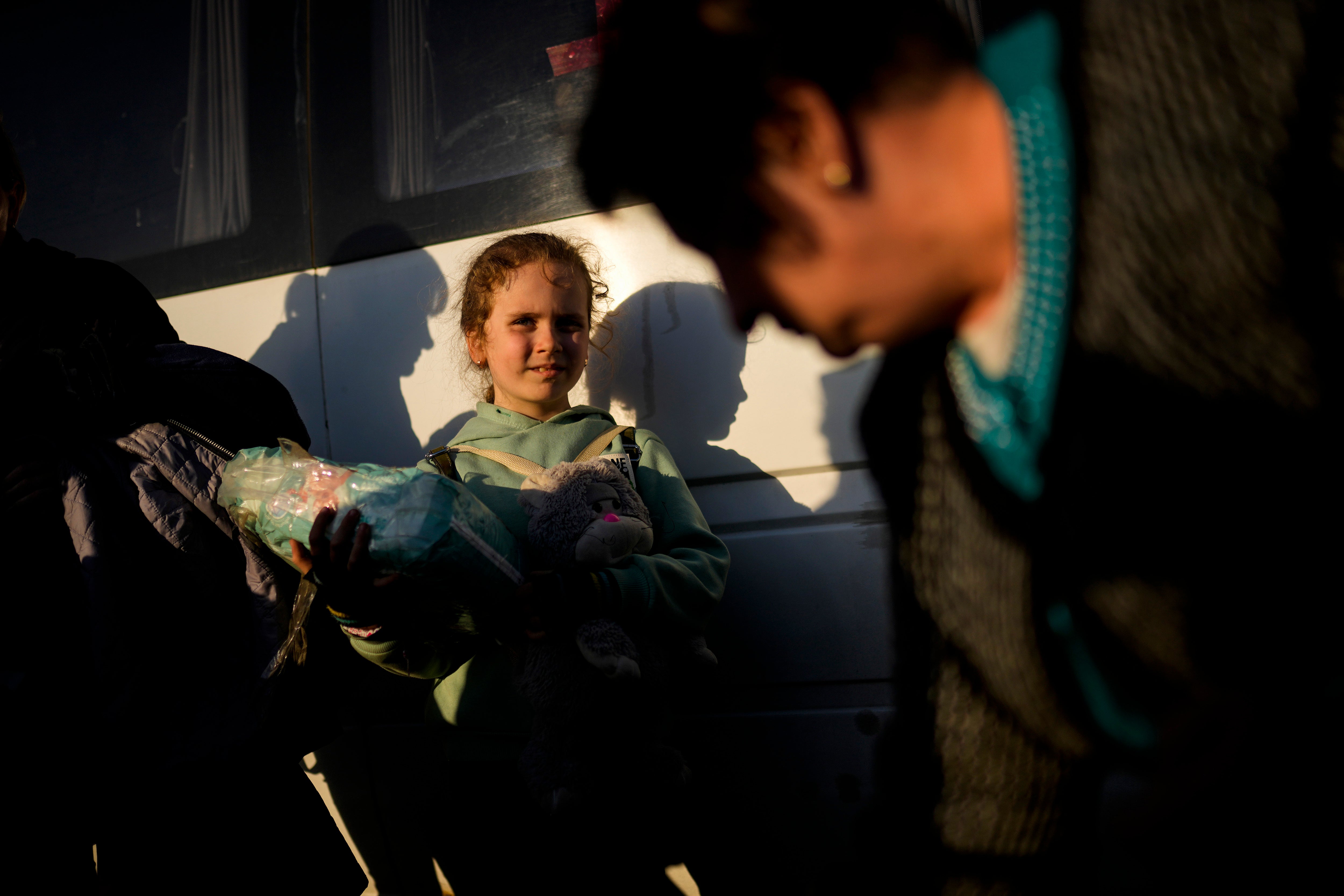A child and her family who fled from Mariupol arrive to a reception center for displaced people in Zaporizhzhia, Ukraine