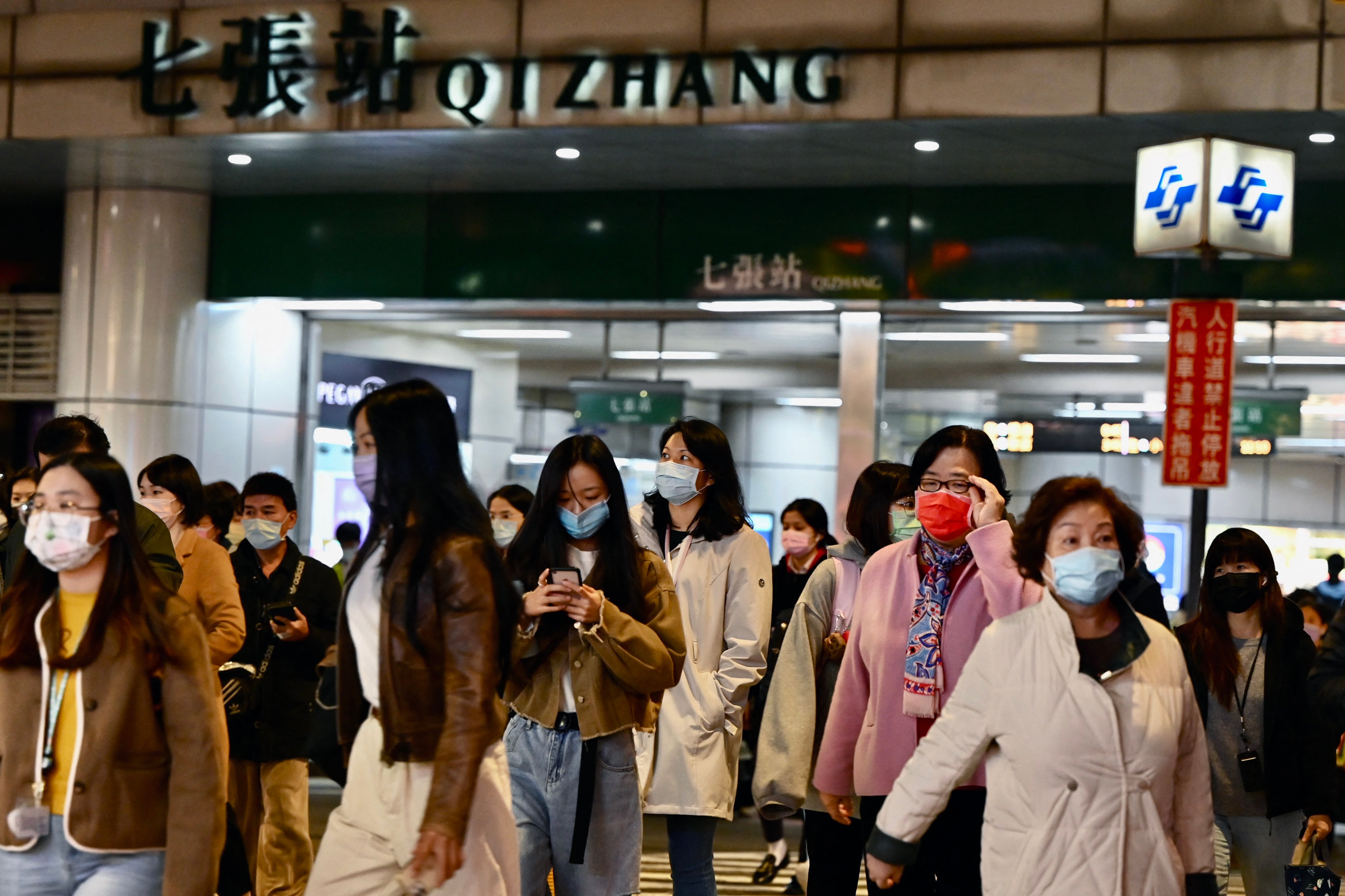 File: Commuters exit a Mass Rapid Transport (MRT) station in Xindian in New Taipei City on 3 January 2022, after a strong earthquake struck off the coast of eastern Taiwan with shaking felt in the capital Taipei