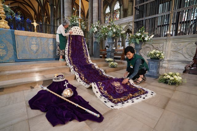 Linda Bainbridge (left) and Miyuki Griffin putting the finishing touches to The Crown, Orb and Sceptre exhibit as part of A Festival of Flowers’ at Salisbury Cathedral (Steve Parsons/PA)
