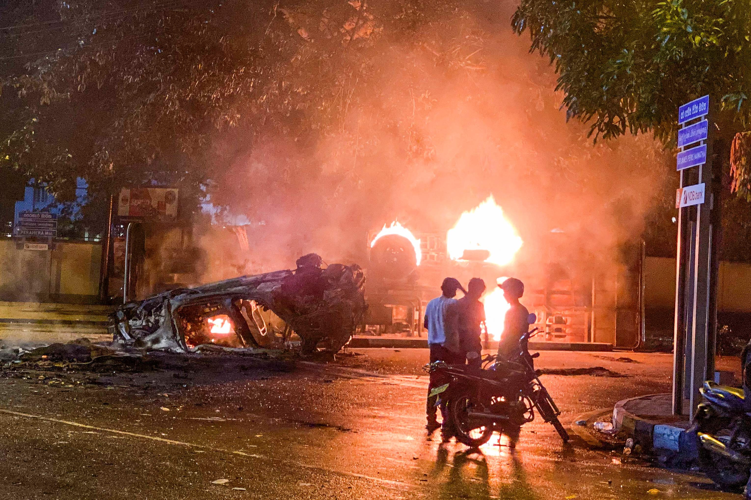 A vehicle belonging to security officials is set ablaze in Colombo on Monday night