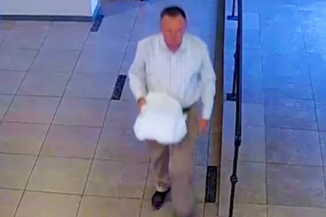 <p>Surveillance footage from a Chandler, Arizona, wedding showing a man police believe to be former Pinal County Sheriff’s Deputy Landon Earl Rankin, 54, stealing a box of wedding cards containing between $3,000 and $6,000.</p>