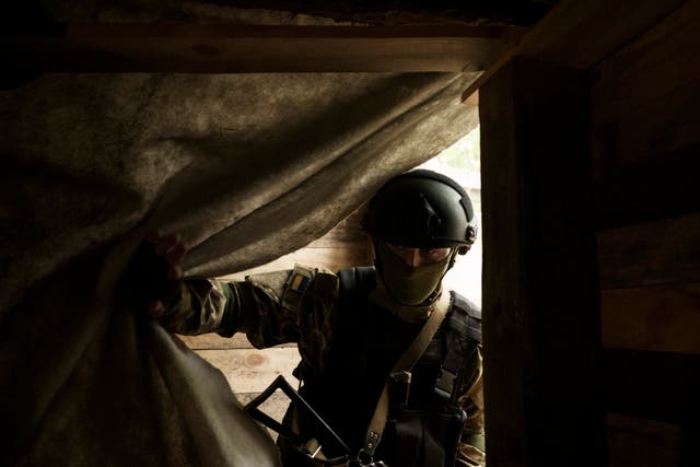 <p>A Ukrainian National Guard soldier enters a underground shelter at a position near Kharkiv, Ukraine, Monday, May 9, 2022.</p>