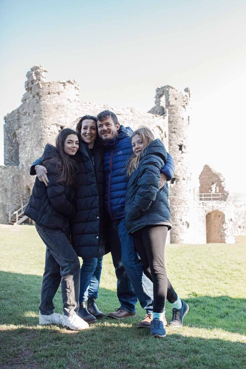 Marian and her family in front of their castle