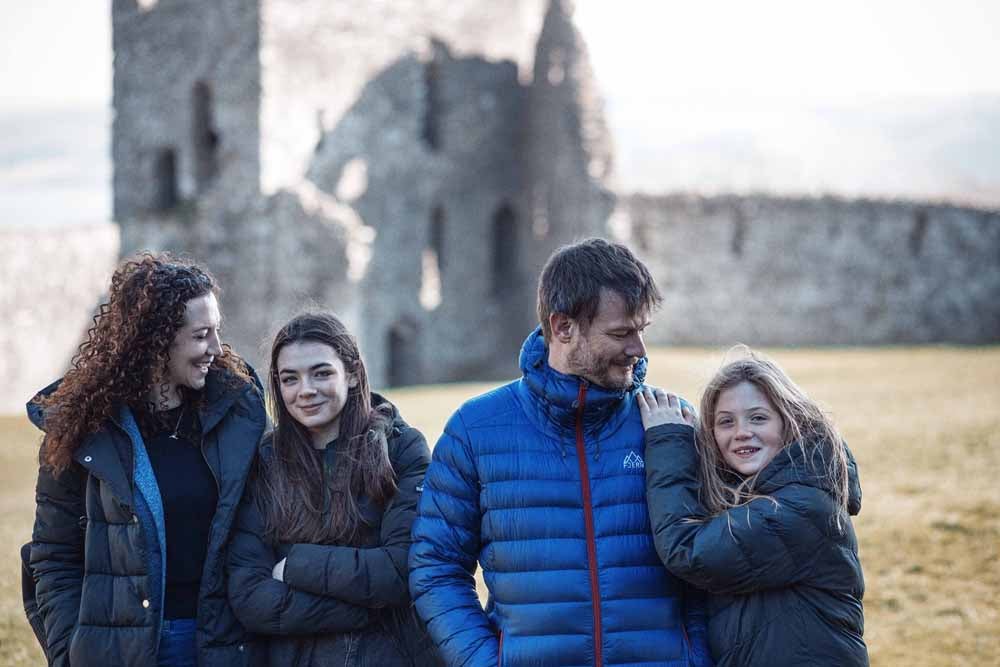 Marian and her family in front of their castle