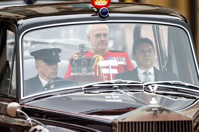 <p>A car carrying Britain's Queen Elizabeth's crown rides by the Buckingham Palace</p>