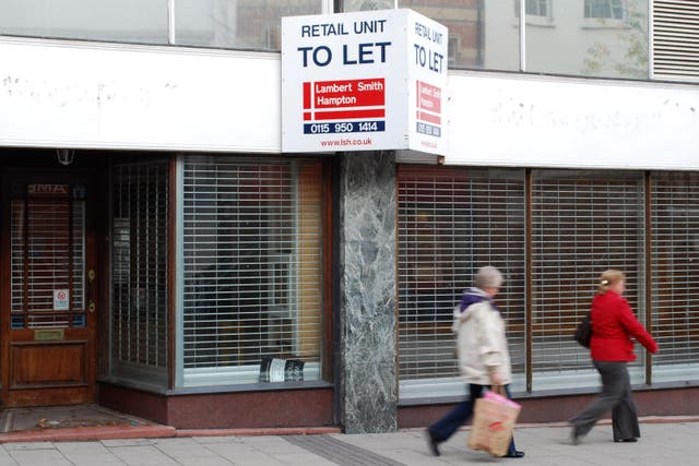 Pedestrians walking past an empty shop unit (PA)