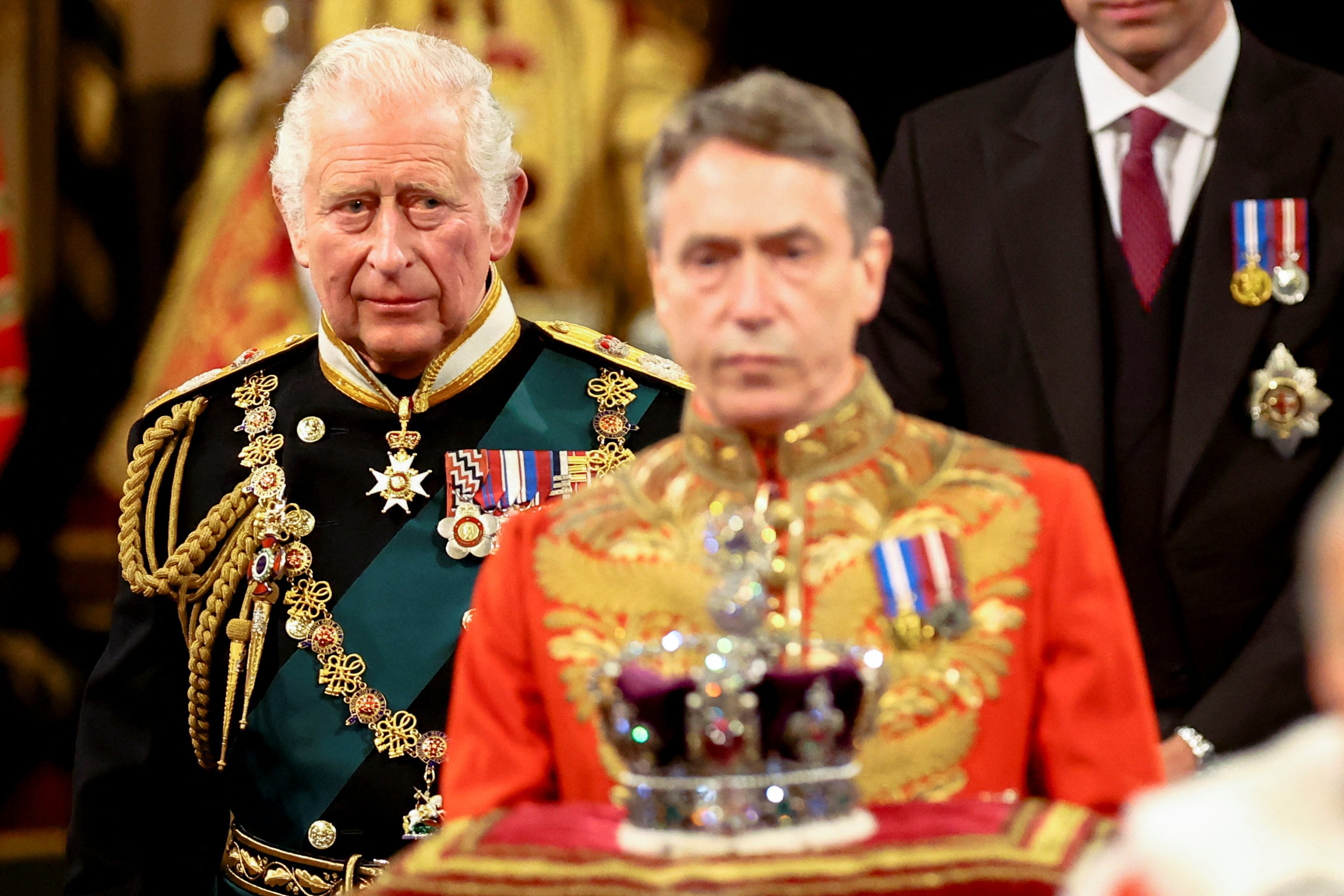 The Prince of Wales walks behind the Imperial State Crown during the State Opening of Parliament in the House of Lords (Hannah McKay/PA)