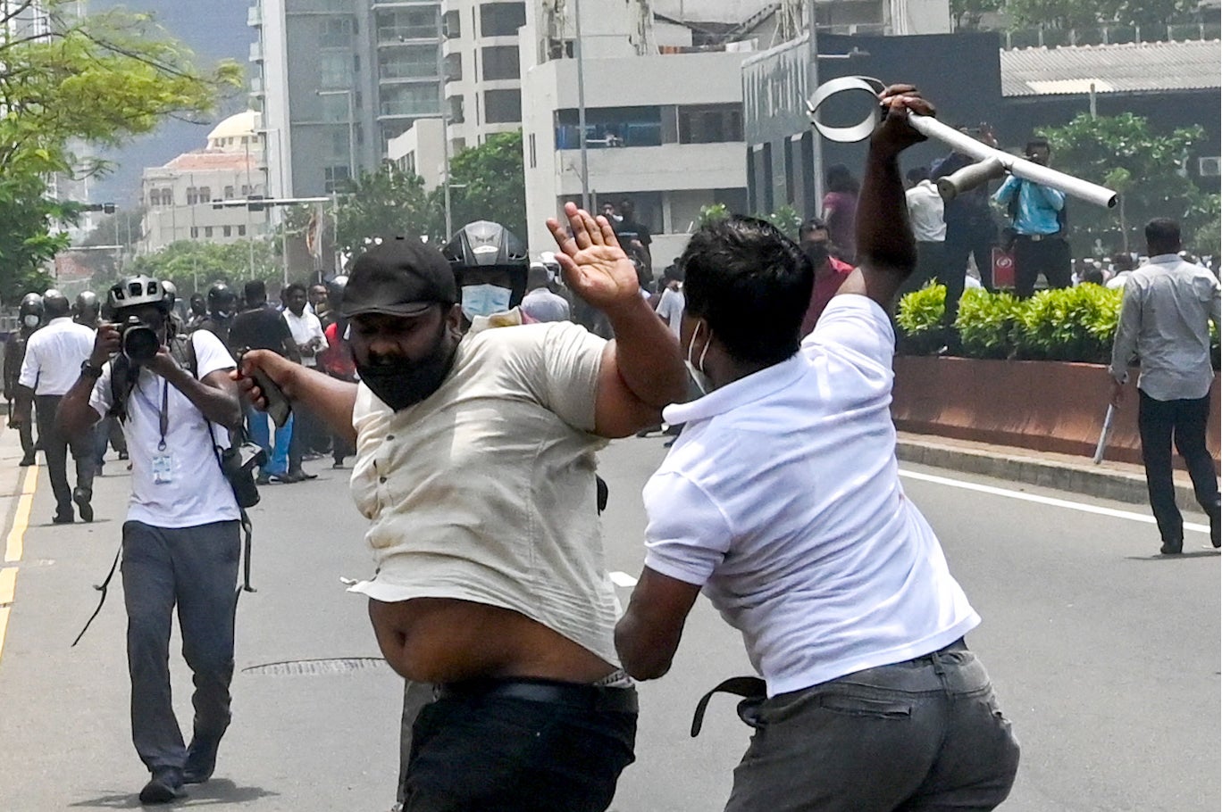 Demonstrators and government supporters clash outside the prime minister’s official residence in Colombo on Monday