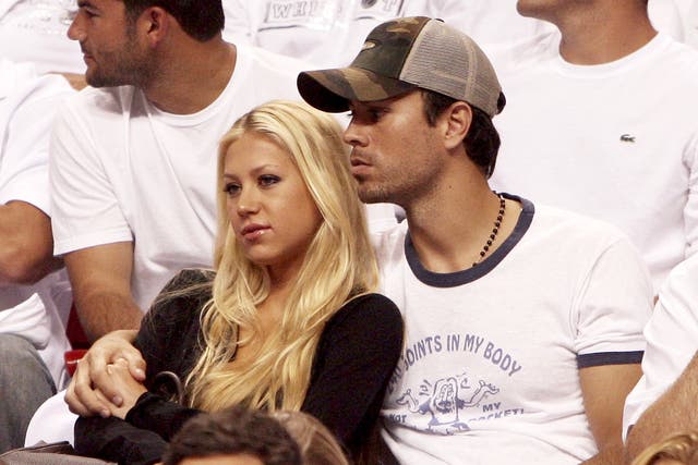 <p> Anna Kournikova and singer Enrique Iglesias hold each other as they watch the the New Jersey Nets take on the Miami Heat in game one of the Eastern Conference semifinals at American Airlines Arena on May 8, 2006</p>