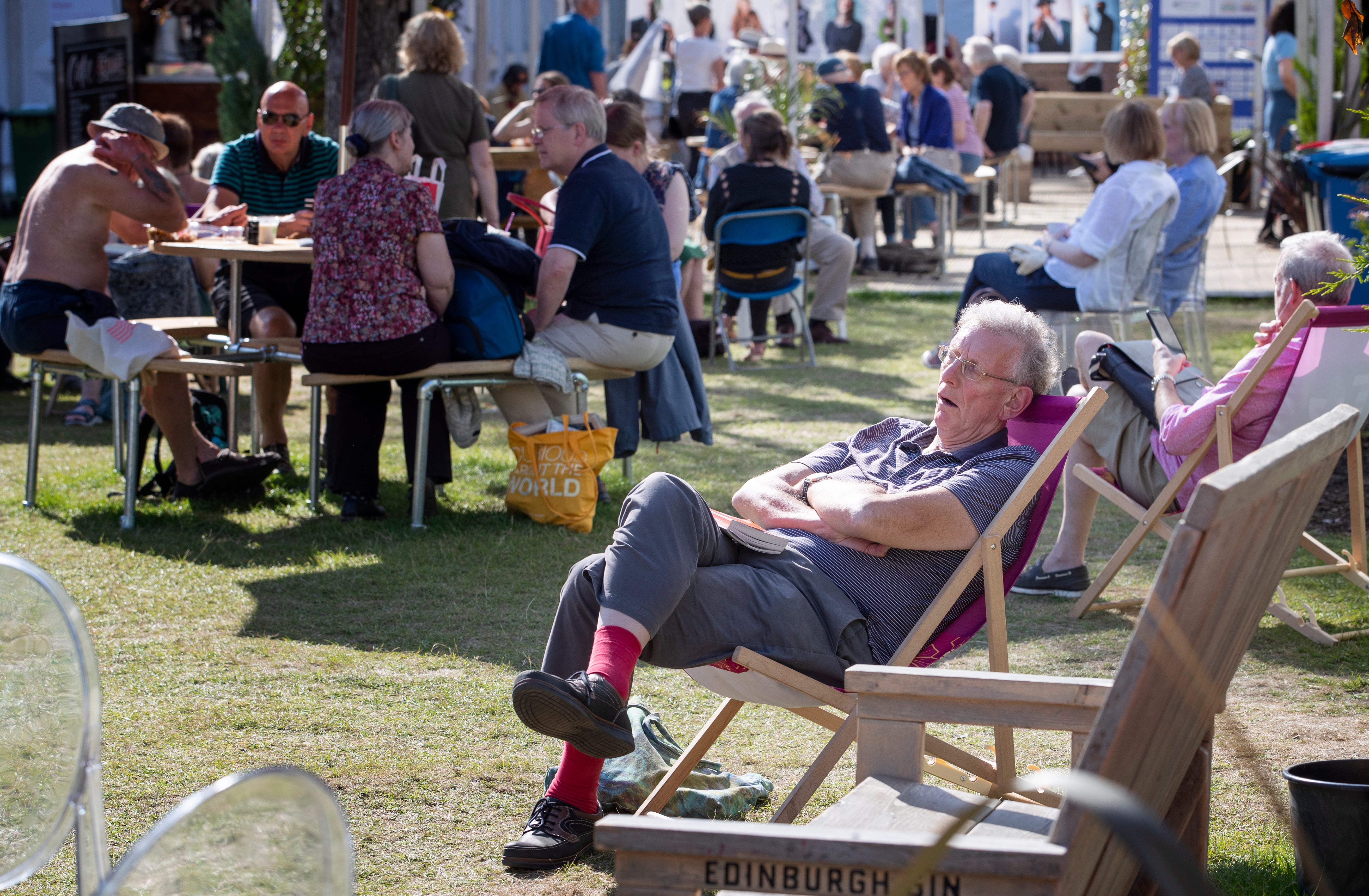 Visitors enjoy the sunshine at the book festival in Charlotte Square Gardens in 2019 (Jane Barlow/PA)