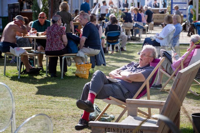 Visitors enjoy the sunshine at the book festival in Charlotte Square Gardens in 2019 (Jane Barlow/PA)