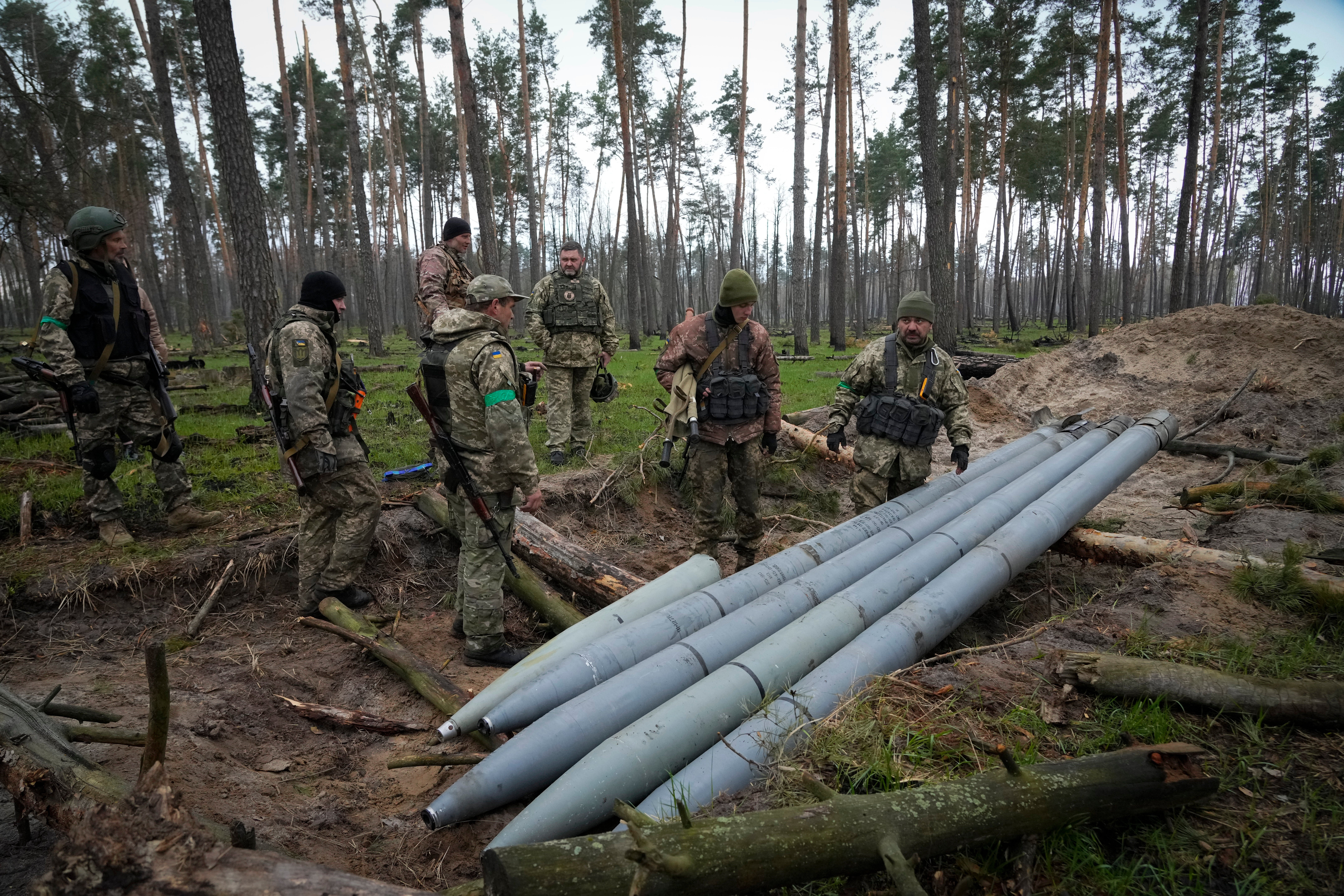 Ukranian soldiers surveying Russian missiles.