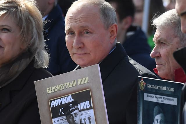 <p>Russian president Vladimir Putin and other participants carry portraits of their relatives, Second World War soldiers, as they take part in the Immortal Regiment march on Red Square </p>