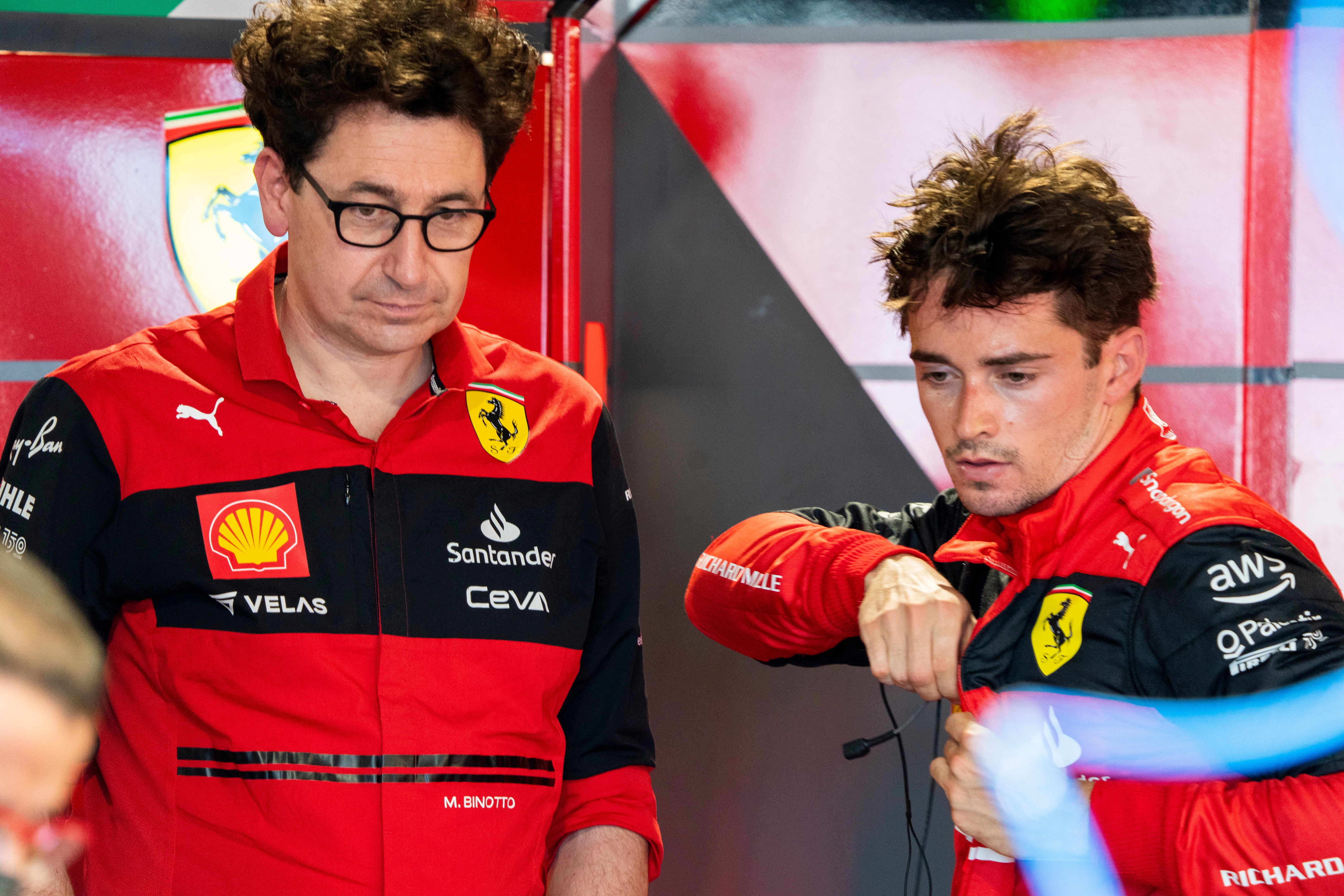 Charles Leclerc of Scuderia Ferrari talks with team principal Mattia Binotto
