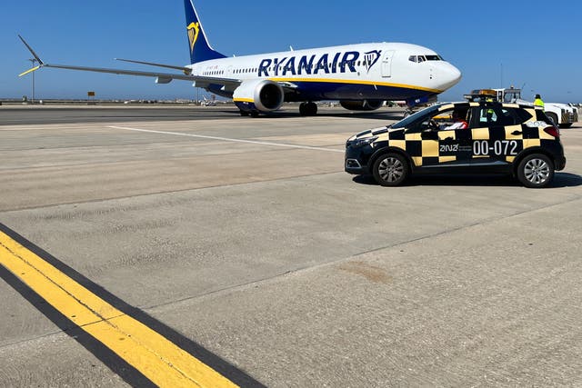 <p>Blue is the colour: Ryanair Boeing 737 Max at Faro airport in Portugal, one of the routes chosen by Rangers fans heading for the Europa League final</p>