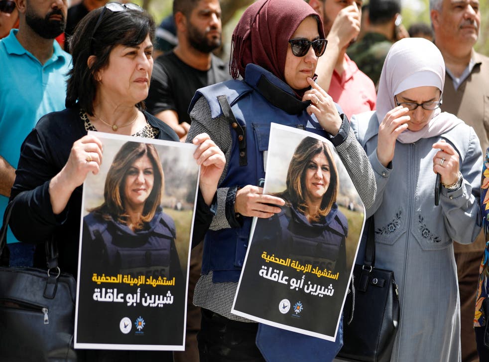 <p>Palestinians hold pictures of Al Jazeera reporter Shireen Abu Akleh, who was killed by Israeli army gunfire during an Israeli raid, according to the Qatar-based news channel, in the West Bank</p>