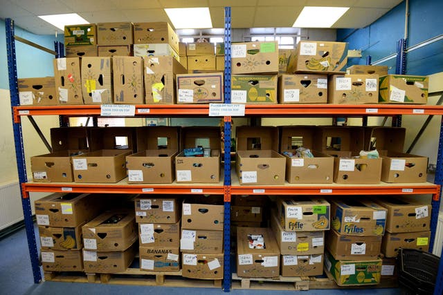 Boxes of food on shelving ready to be picked for distribution at the Bromley Borough Foodbank in Orpington, part of The Trussell Trust (Andrew Matthews/PA)