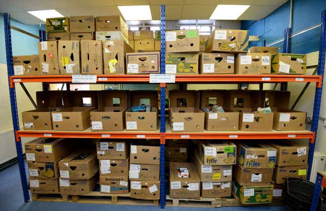 Boxes of food on shelving ready to be picked for distribution at the Bromley Borough Foodbank in Orpington, part of The Trussell Trust (Andrew Matthews/PA)