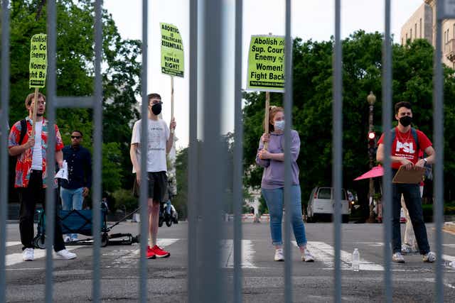 <p>Pro-choice demonstrators are seen through police barricades in front of the US Supreme Court in Washington, DC, on May 11, 2022</p>