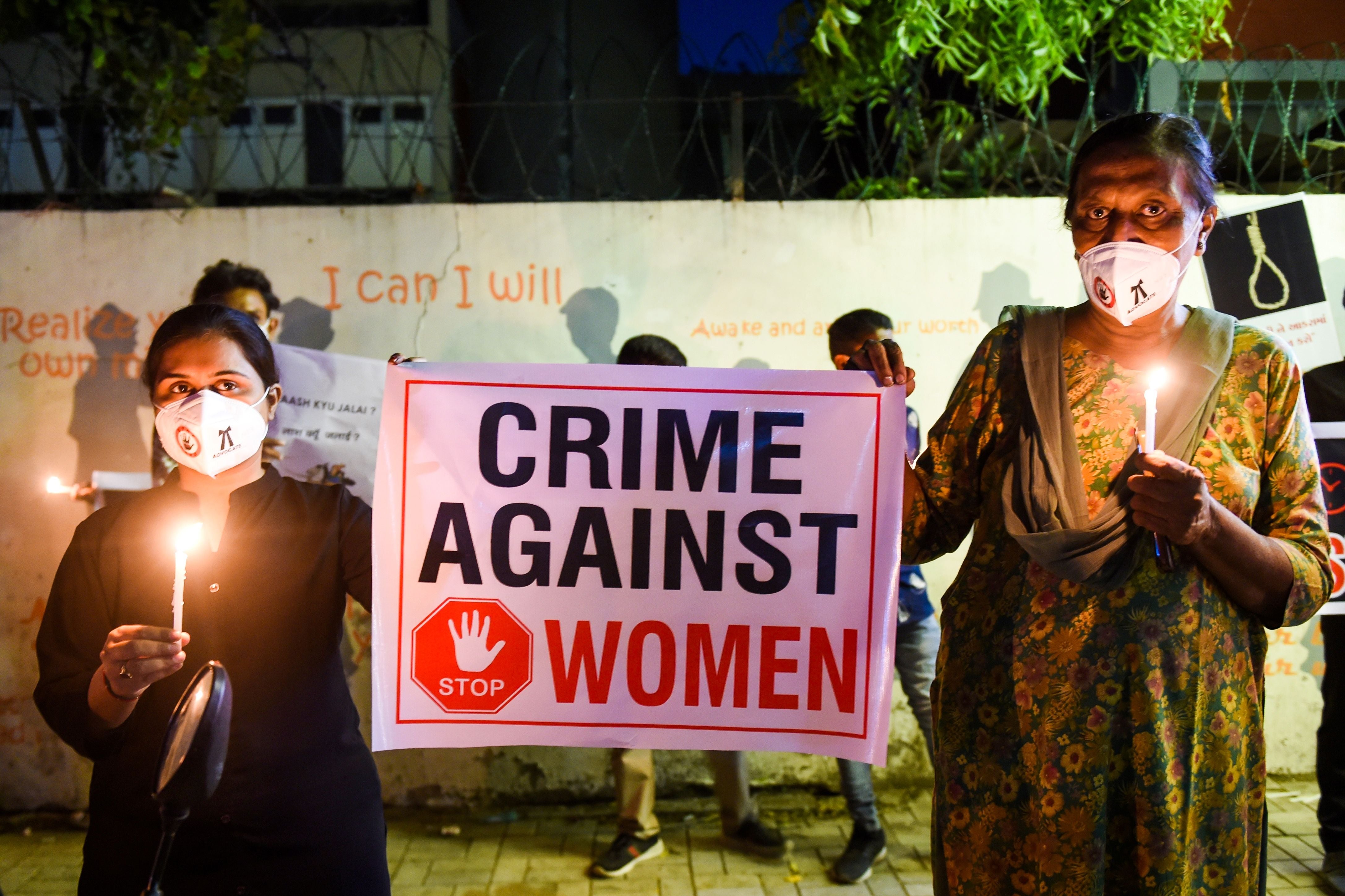 Protesters in India holding a placard to condemn violence against women