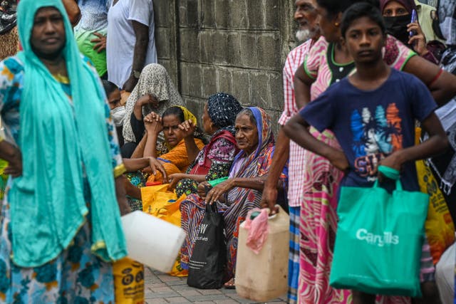 <p>People queue up to buy kerosine for domestic use at a supply station after authorities relaxed the ongoing curfew for a few hours in Colombo</p>