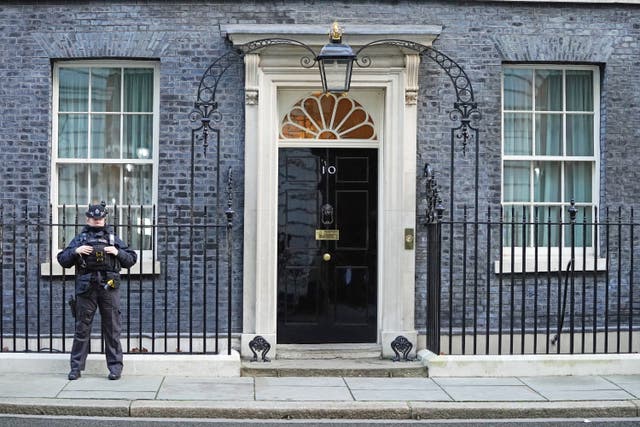 <p>A police officer stands at the door of the Prime Minister’s official residence in Downing Street</p>
