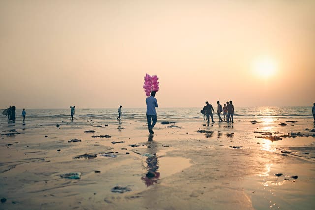 <p>File. A man selling candy floss at a beach in Mumbai, India </p>