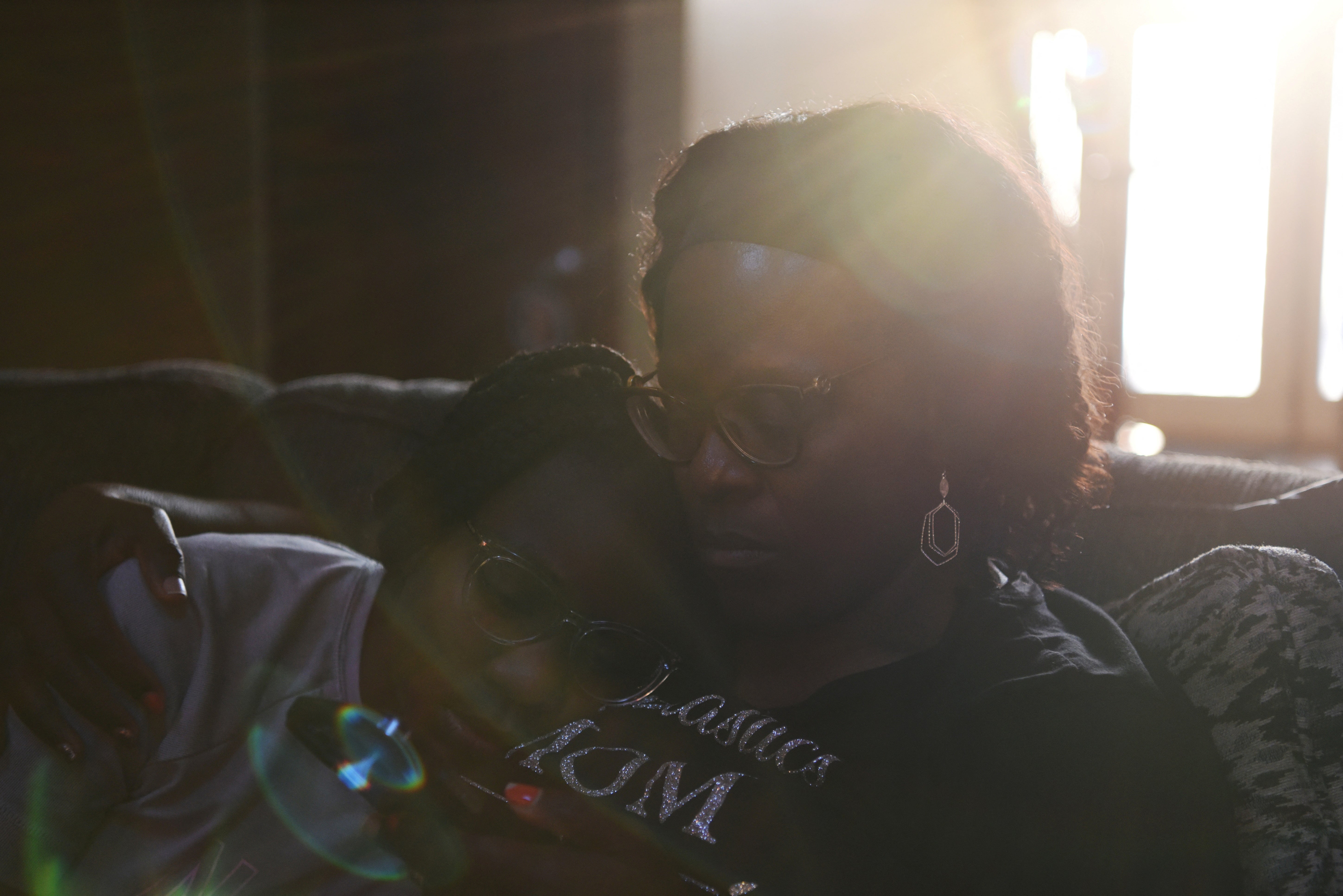 Justise McGowan, 13, rests her head on her mother, Dr. Sandra McGowan-Watts, at home in Matteson, Illinois