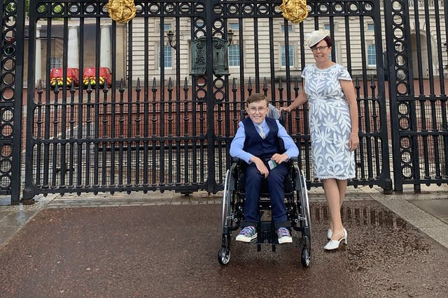 Tobias Weller, 11, with his mother Ruth Garbutt at Buckingham Palace (Family handout/PA)