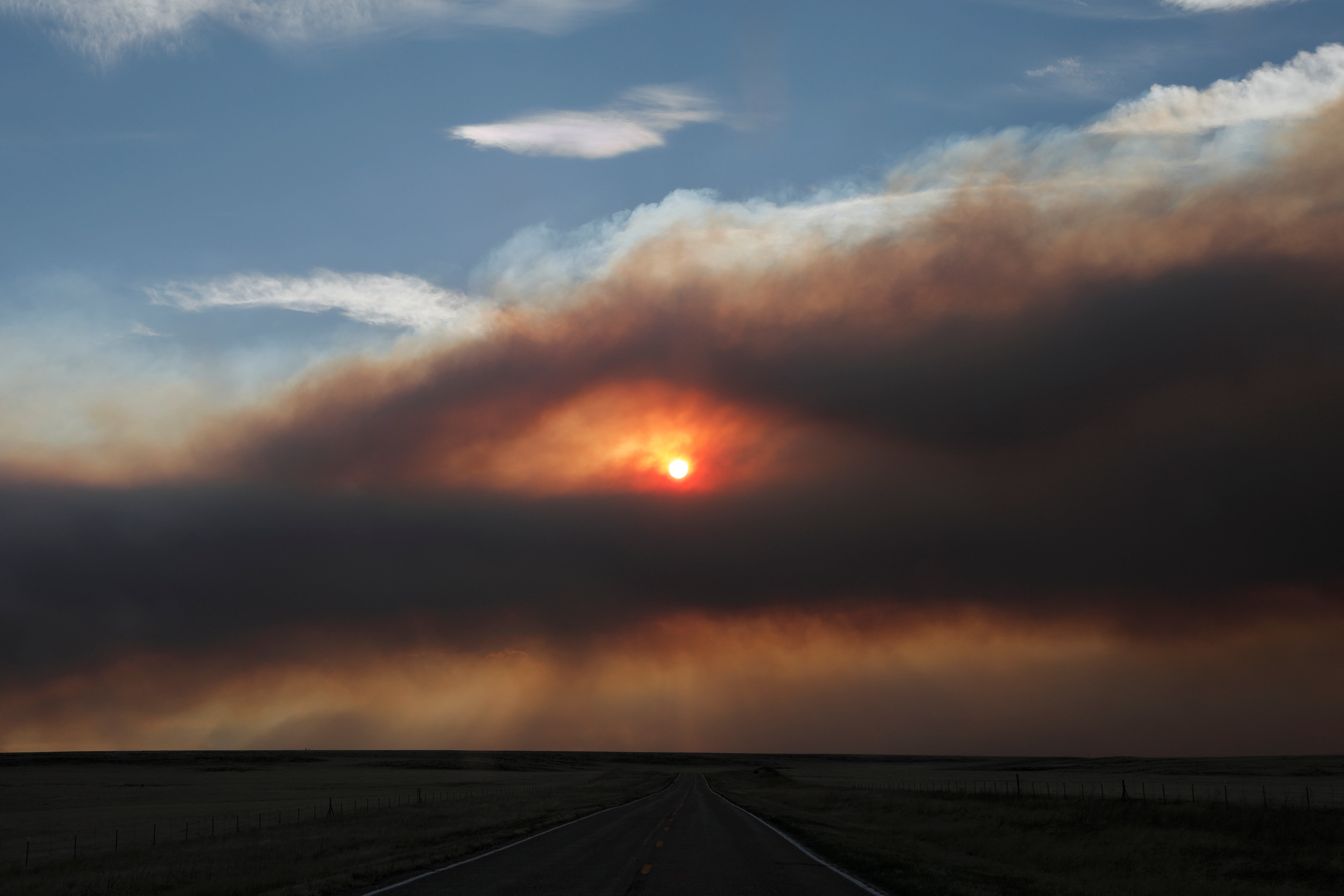 The sun burns through a smoky sky outside Ocate, NM as the Calf Canyon/Hermits Peak fire continues to spread