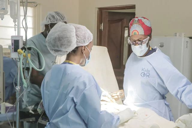 Dr Neema Kaseje, right, and a surgical team working in a KidsOR (Kids Operating Room (KidsOR)/PA)