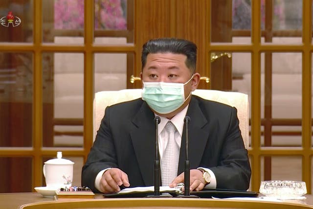 <p>North Korean leader Kim Jong Un wears a face mask on state television during a meeting acknowledging the country’s first case of Covid-19 </p>