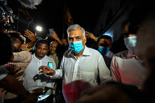 <p>Sri Lanka’s new prime minister Ranil Wickremesinghe visits a Buddhist temple after his swearing-in ceremony in Colombo</p>