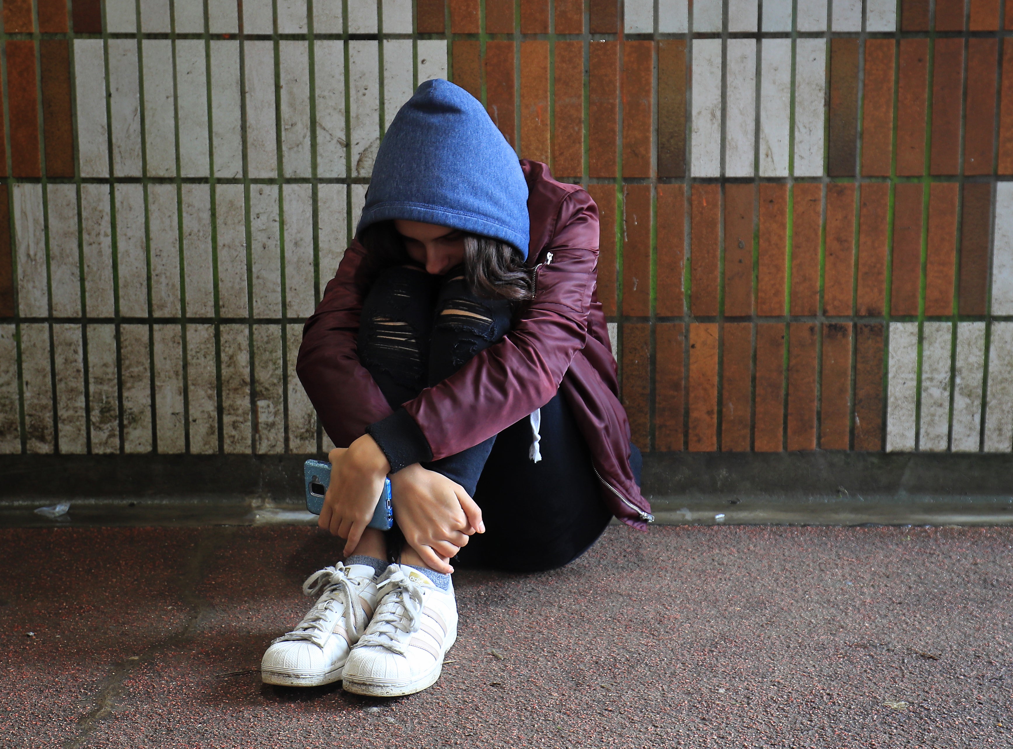 A picture posed by a model of a teenage girl showing signs of mental health issues (Gareth Fuller/PA)