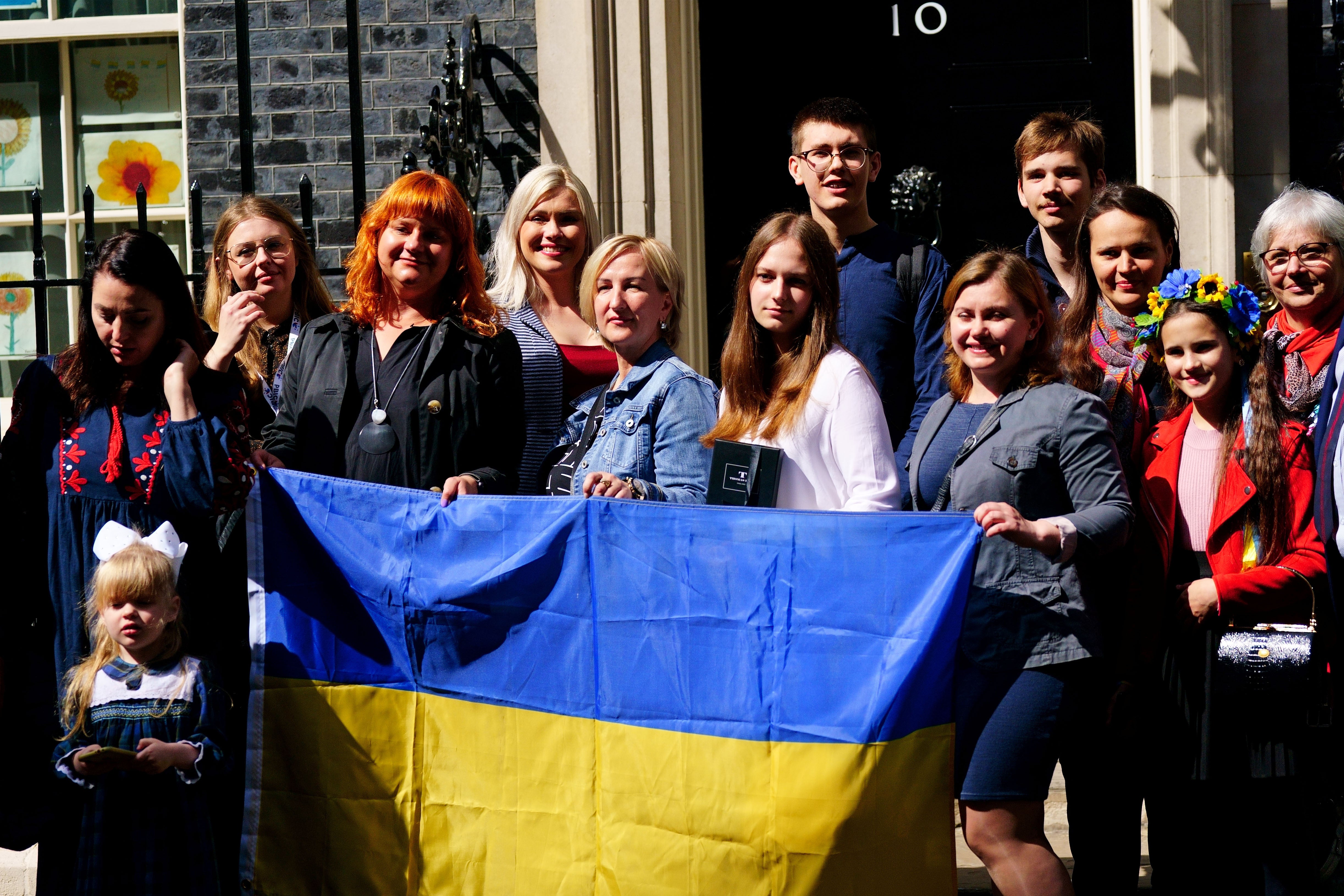 A number of Ukrainian families stand on the doorstep of 10 Downing Street
