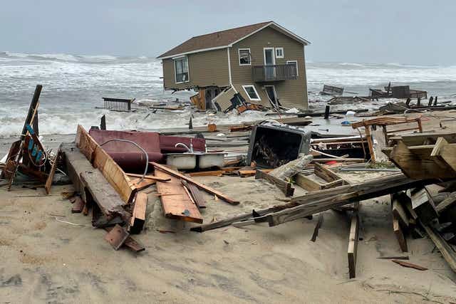 <p>A collapsed home washes into the sea this week in Rondanthe, North Carolina</p>