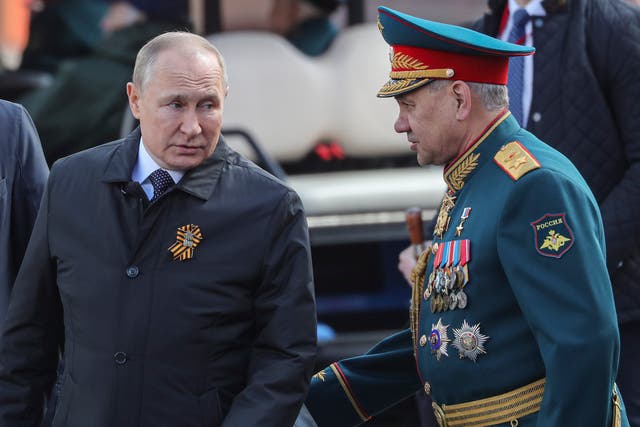 <p>Russian president Vladimir Putin (L) speaks with Russian Defense Minister Sergei Shoigu as they attend the Victory Day military parade on the Red Square in Moscow, Russia, 09 May 2022</p>