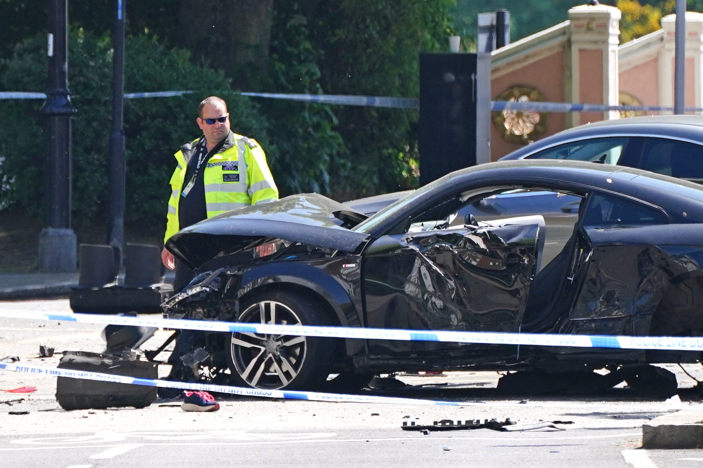 A police officer at the scene at Cheyne Walk in Chelsea, London, after a 41-year-old woman and three dogs have been killed following a car crash