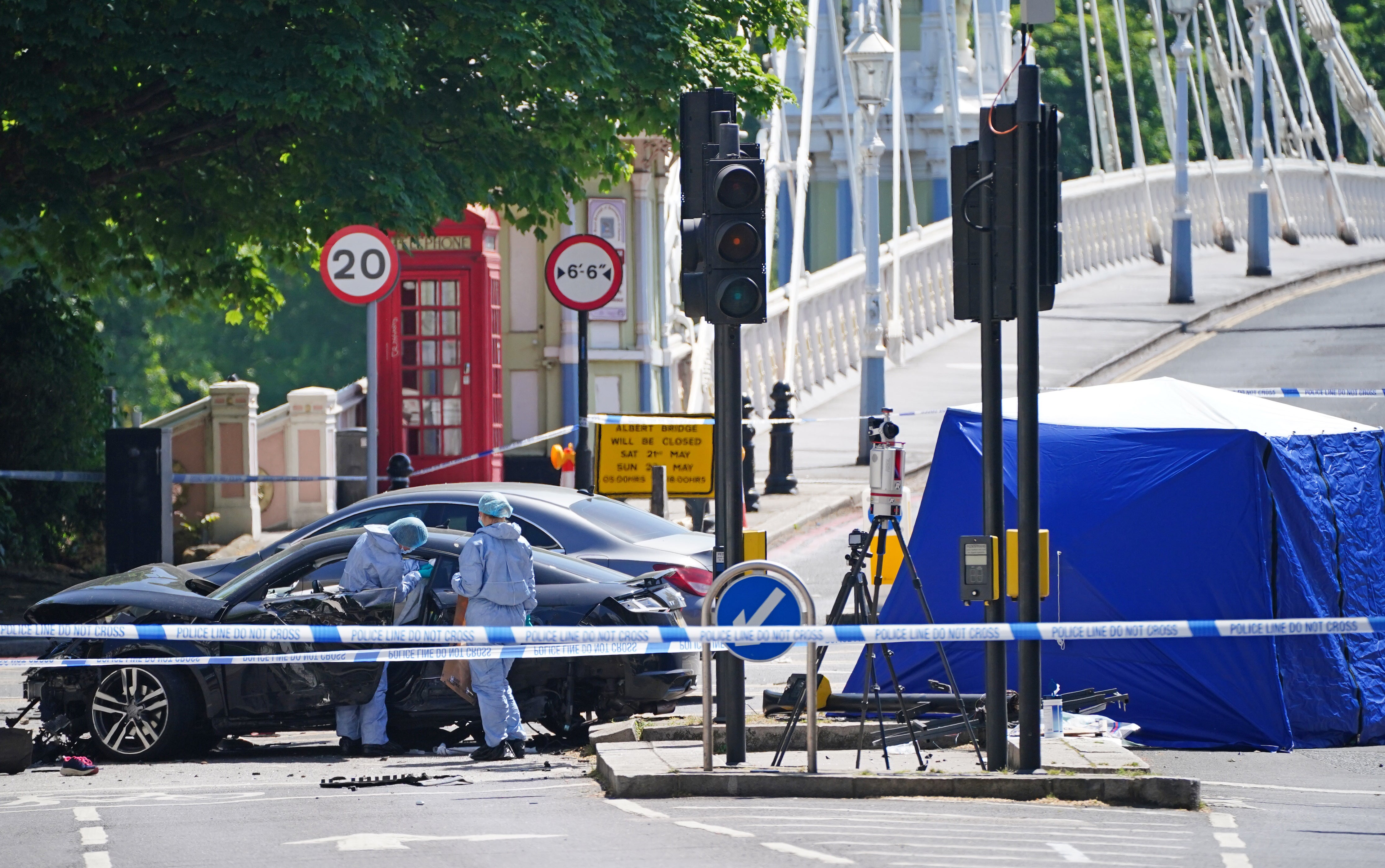 Police forensic officers at the scene at Cheyne Walk in Chelsea, London, after a 41-year-old woman and three dogs have been killed following a car crash.